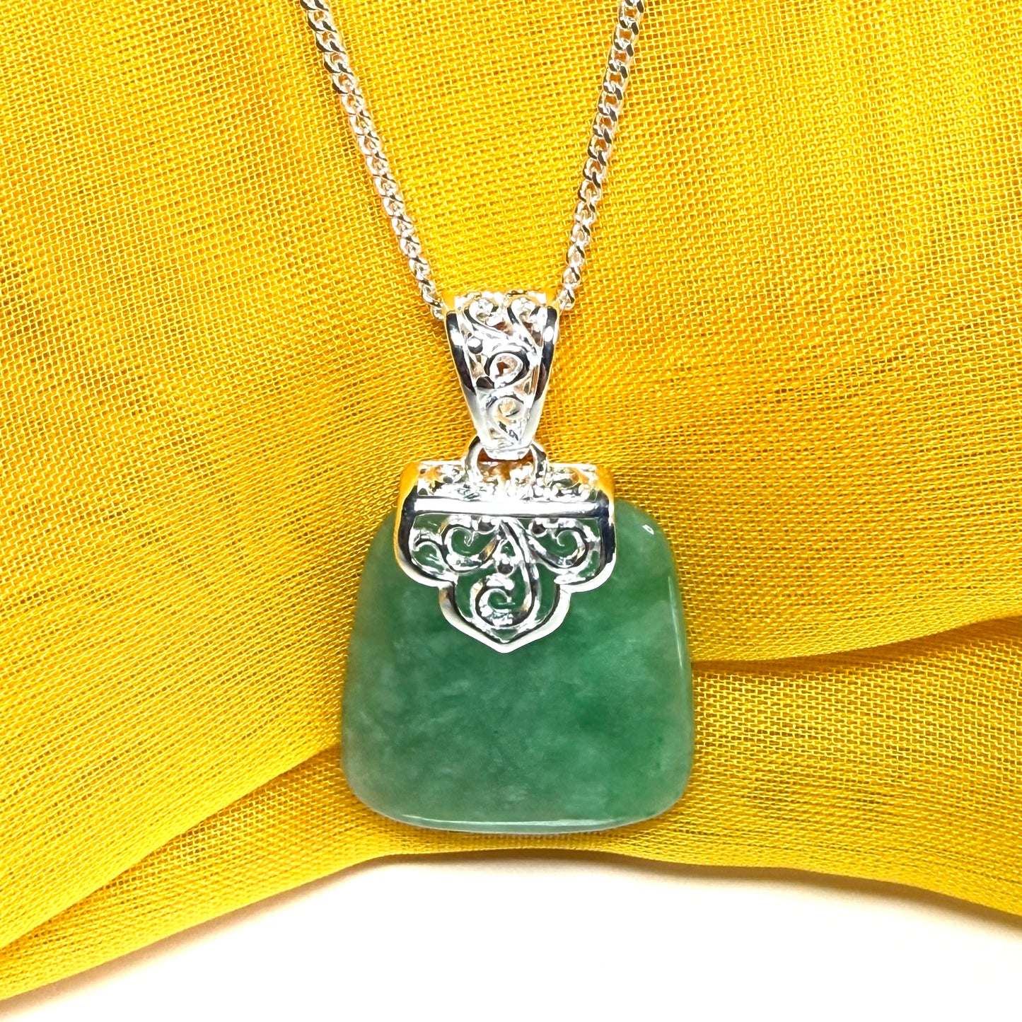 A real green jade necklace sterling silver large cushion shaped including a curb chain, beautiful