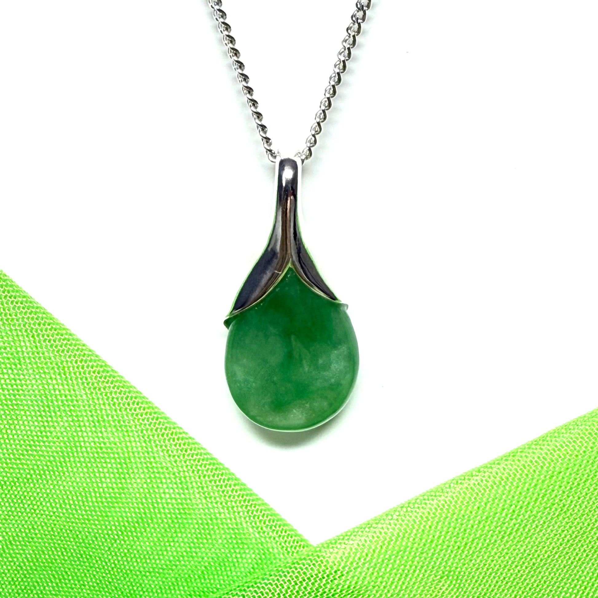 A real green jade necklace teardrop with a pear shaped pendant, with chain included