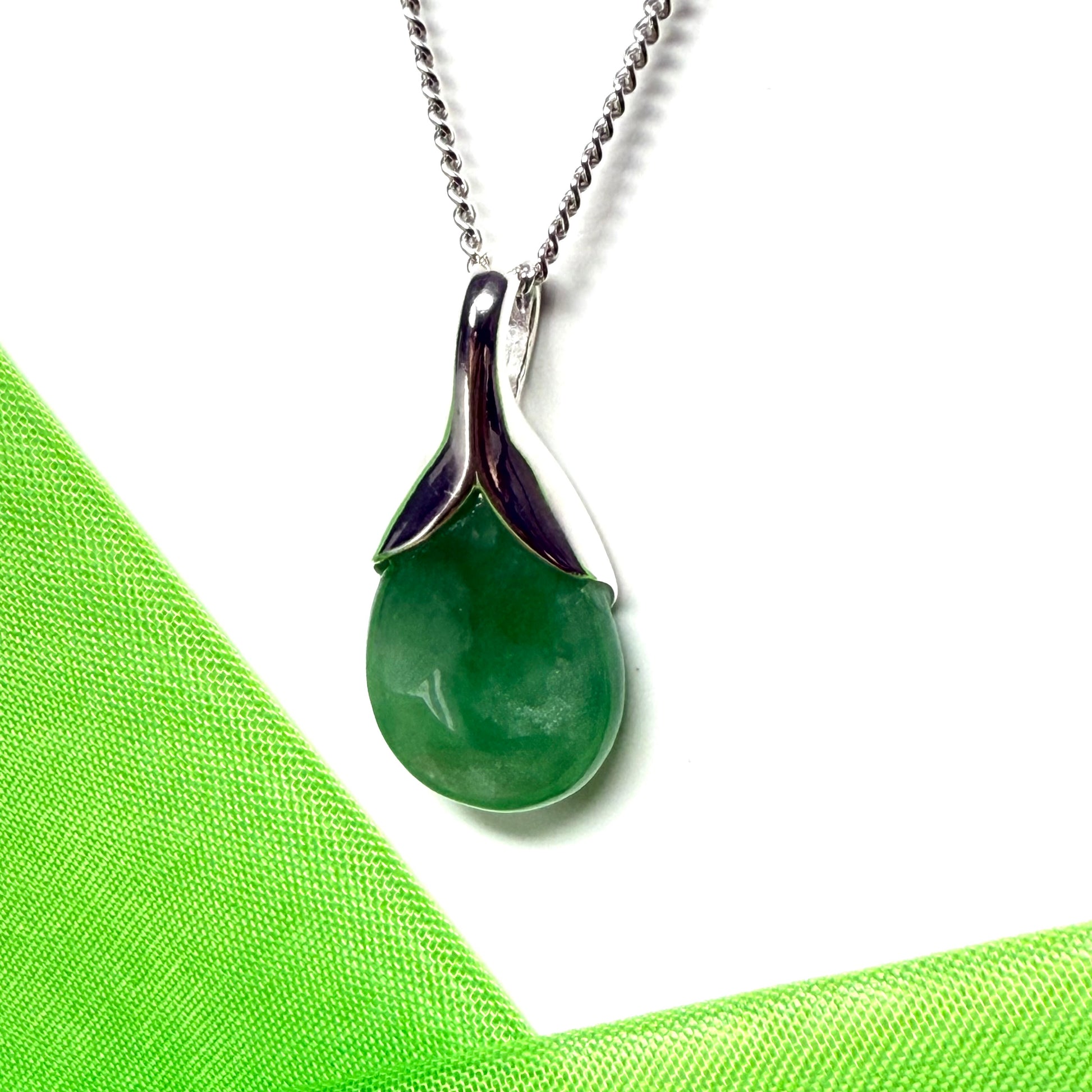 A real green jade necklace teardrop with a pear shaped pendant, with chain included