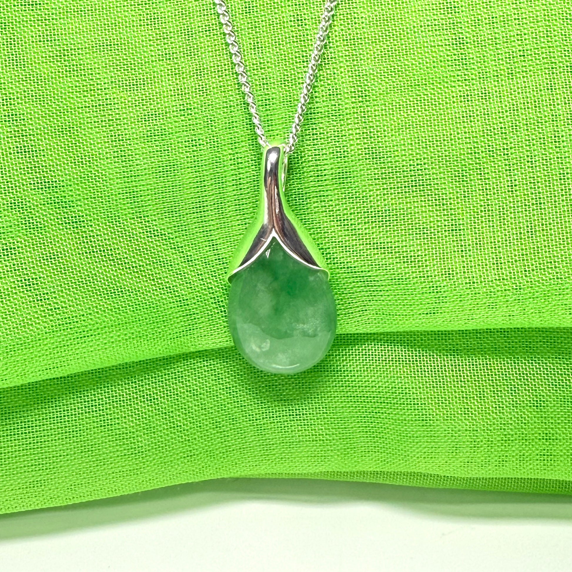 A real green jade necklace teardrop with a pear shaped pendant, with chain included
