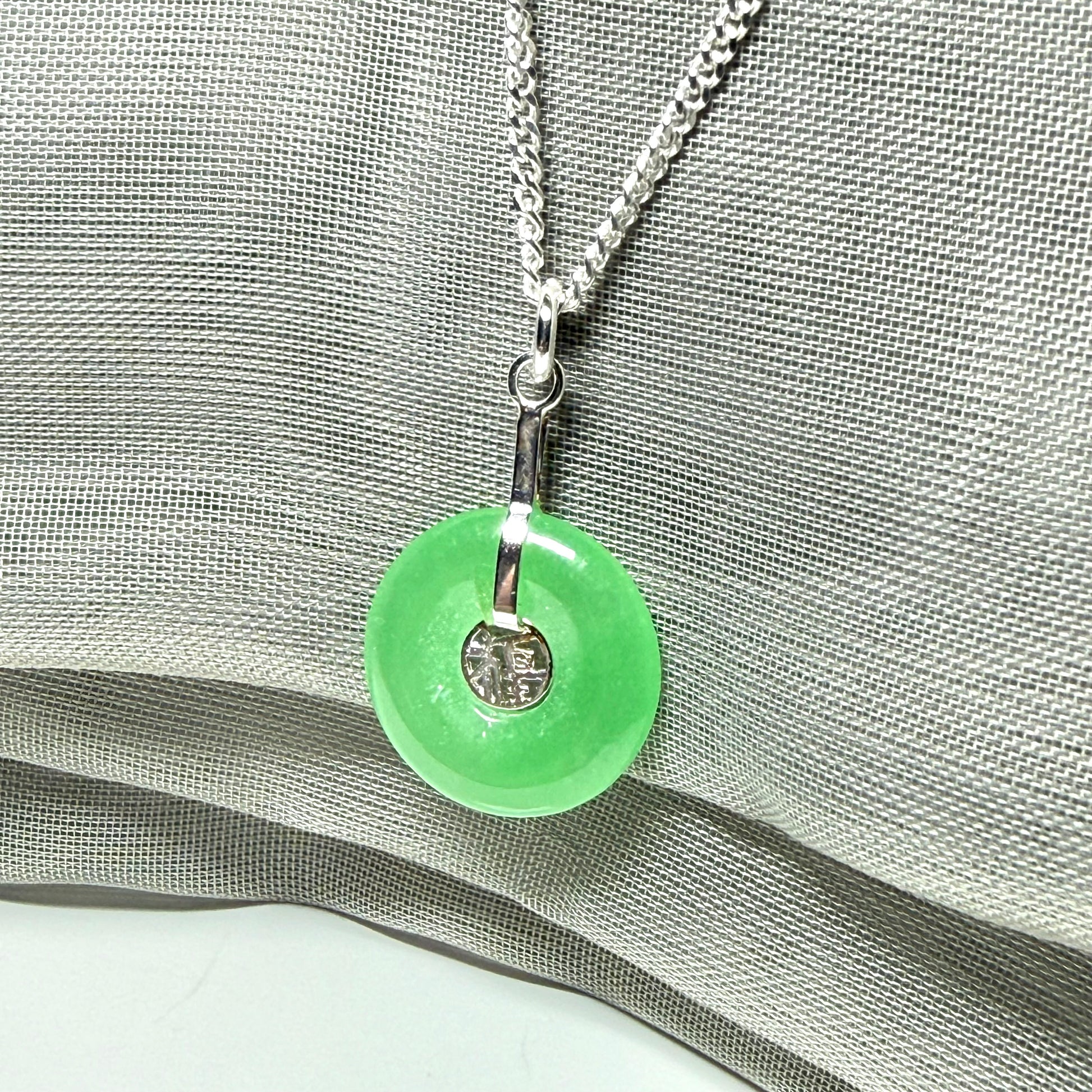 Real green jade necklace with a round pendant sterling silver and a chain