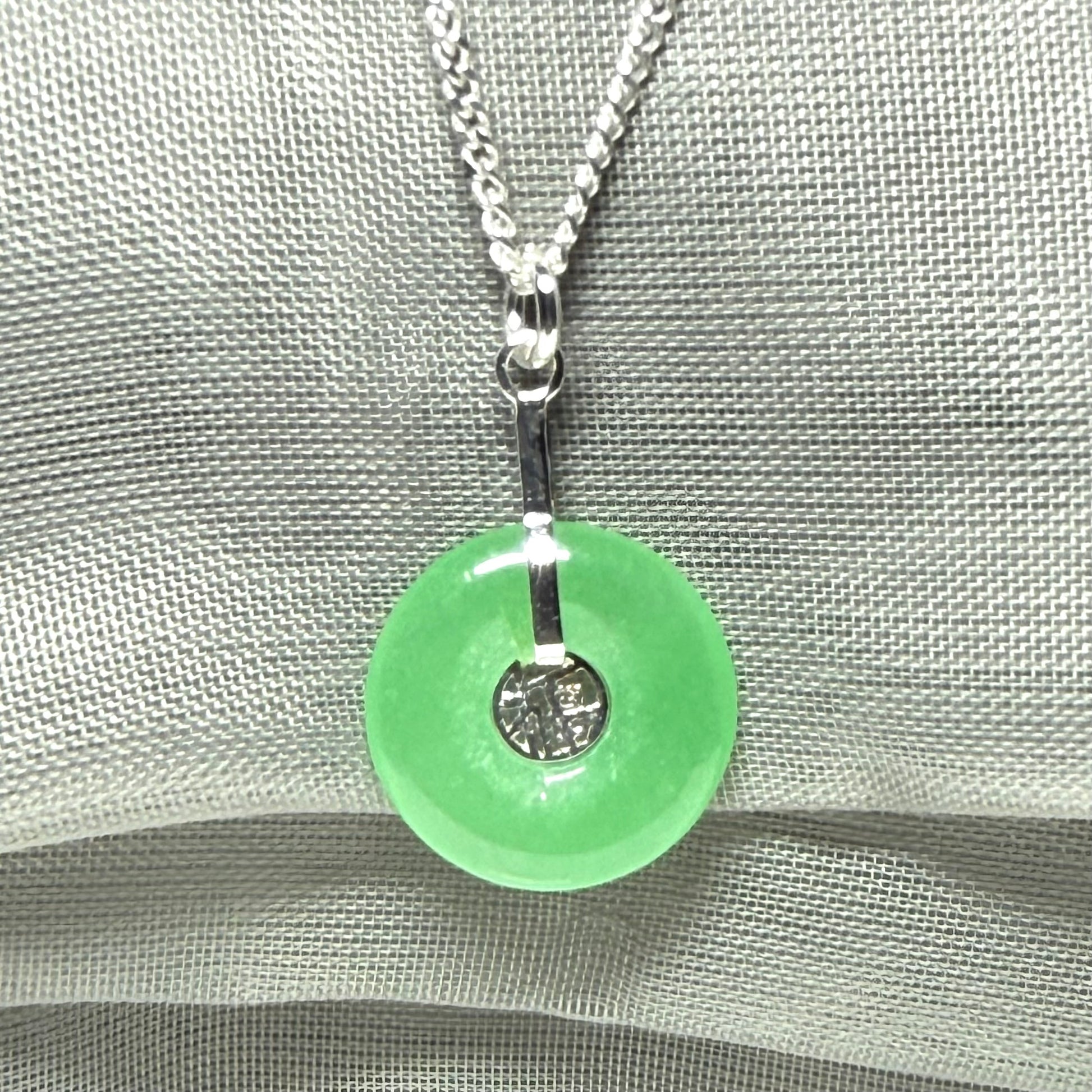 Real green jade necklace with a round pendant sterling silver and a chain