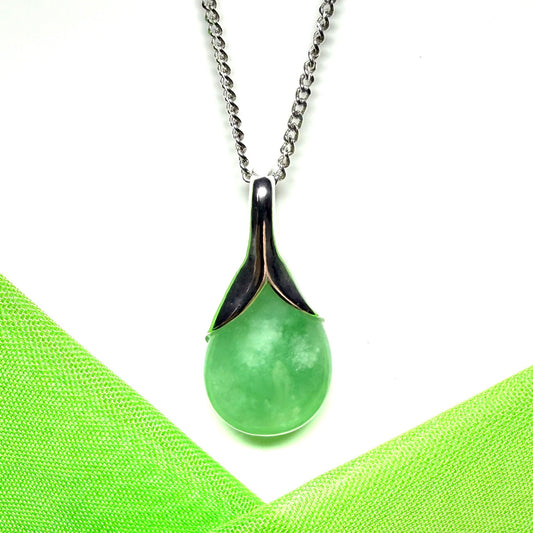 A real green jade pear shape necklace in a teardrop pendant with a chain included