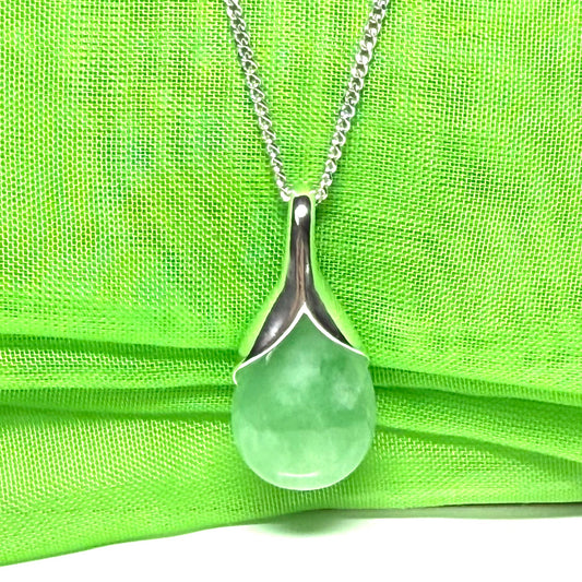 A real green jade pear shape necklace in a teardrop pendant with a chain included
