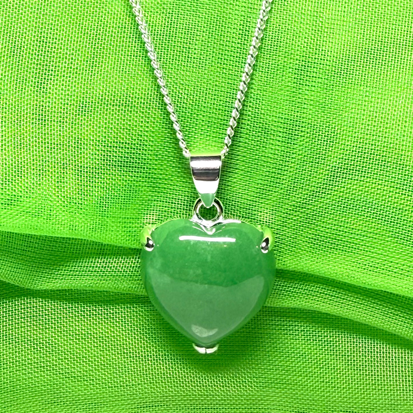 A real green jade pendant heart shaped sterling silver, a traditionally designed necklace