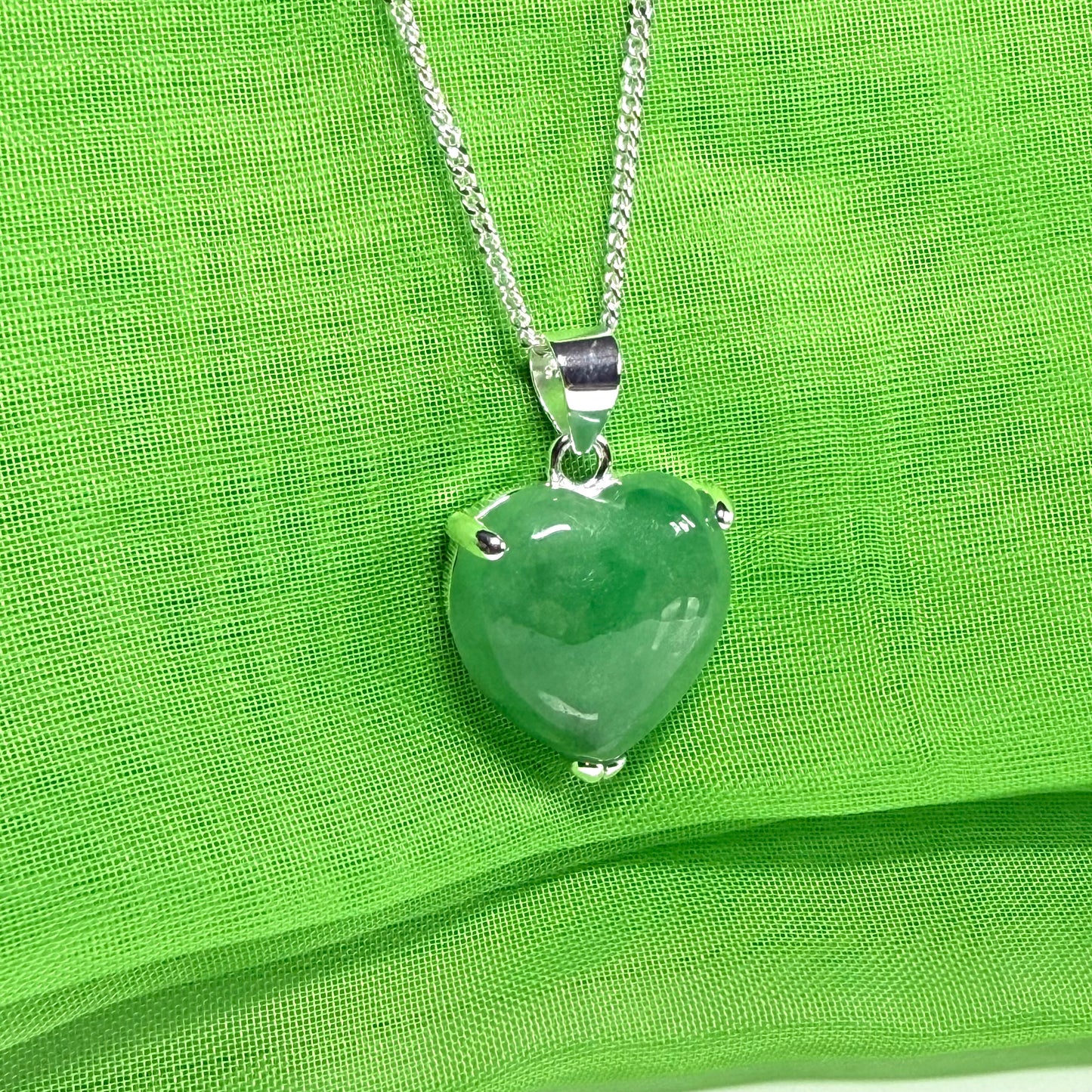 A real green jade pendant heart shaped sterling silver, an eye opening designed necklace