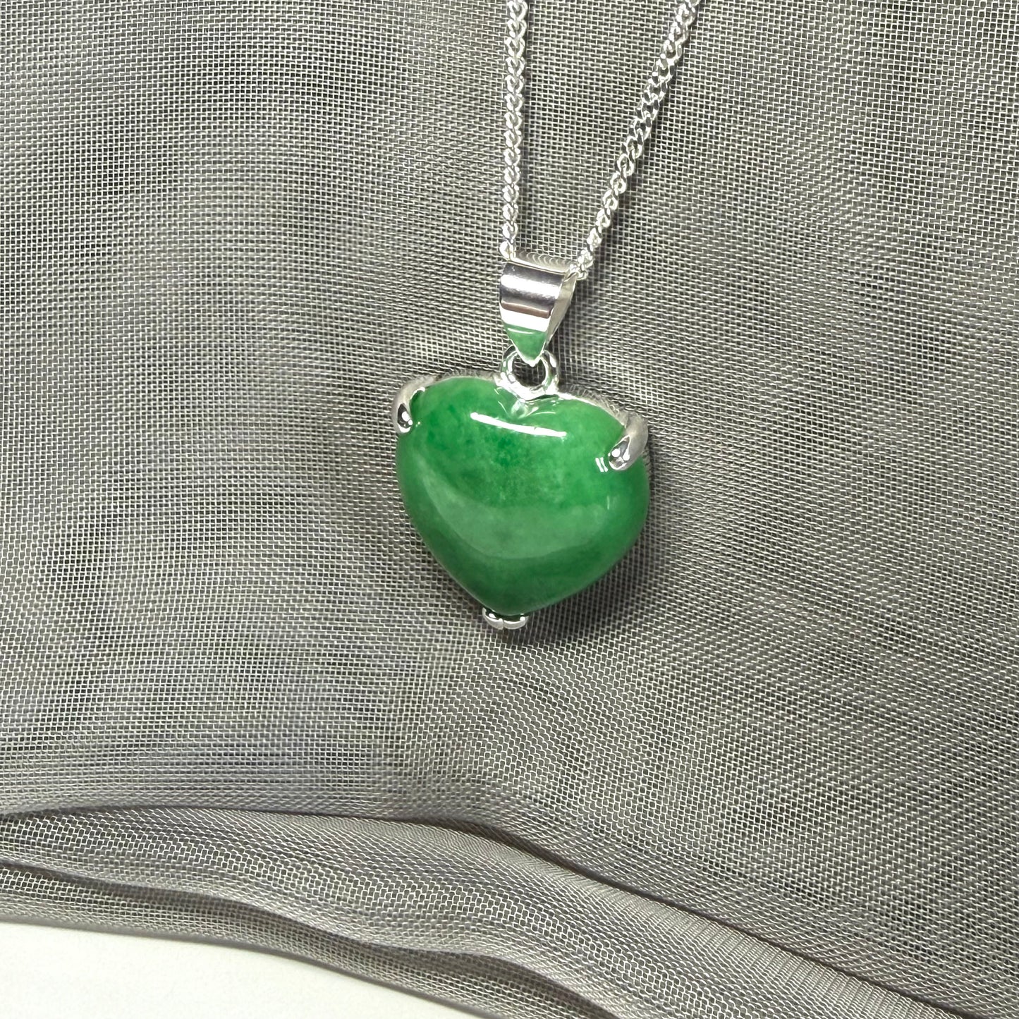 A real green jade pendant heart shaped sterling silver, a traditional designed necklace