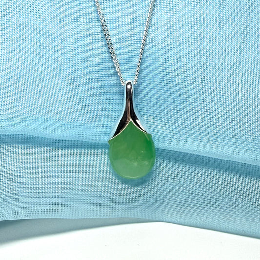 A real green jade pendant necklace in a distinctive teardrop shape or pear shaped design