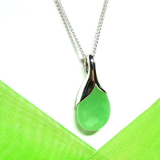 A real green jade pendant necklace in a teardrop shaped or pear shaped design to it