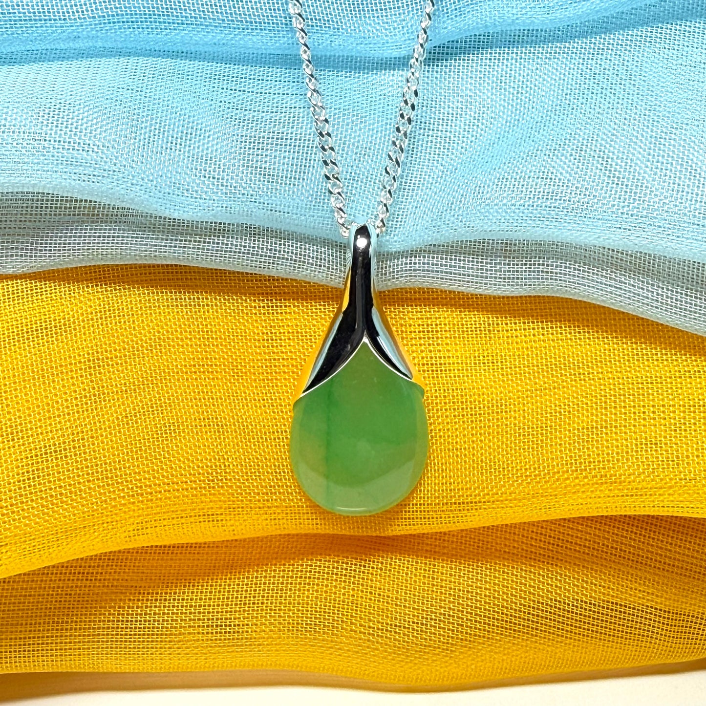 A real jade teardrop shaped designed green necklace or pear shape pendant