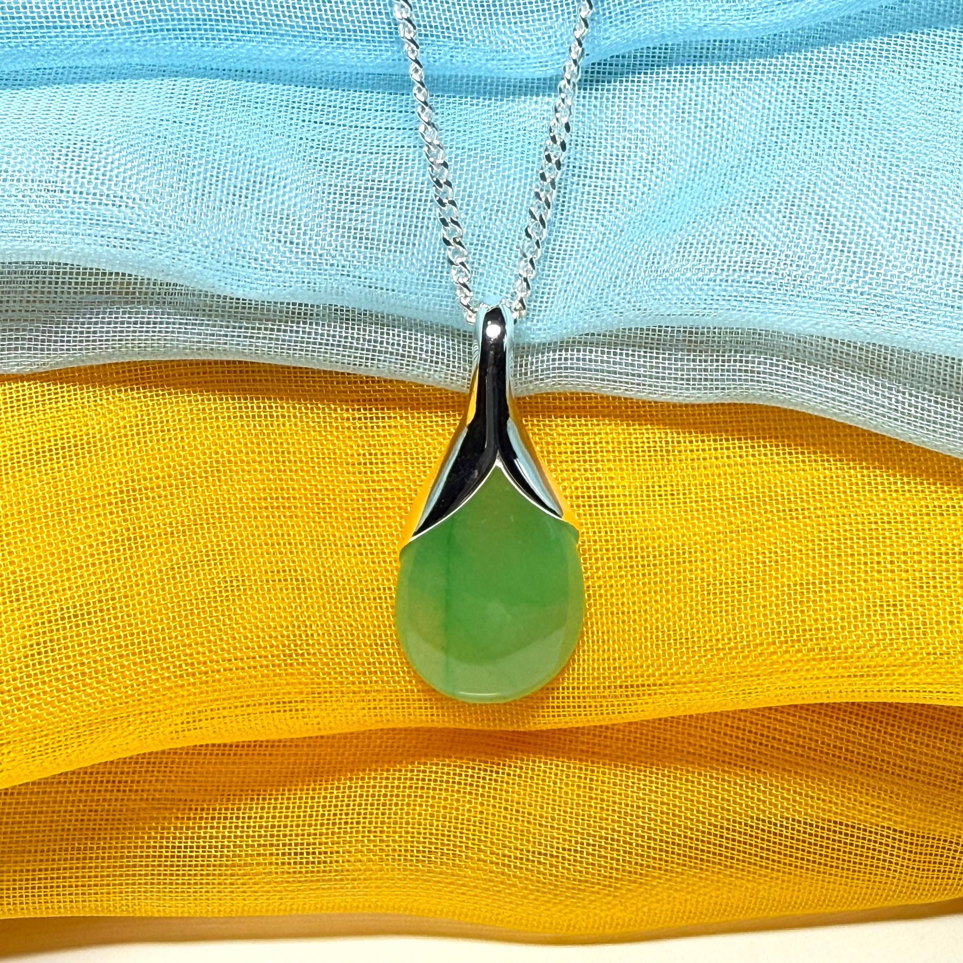 A real jade teardrop shaped designed green necklace or pear shape pendant