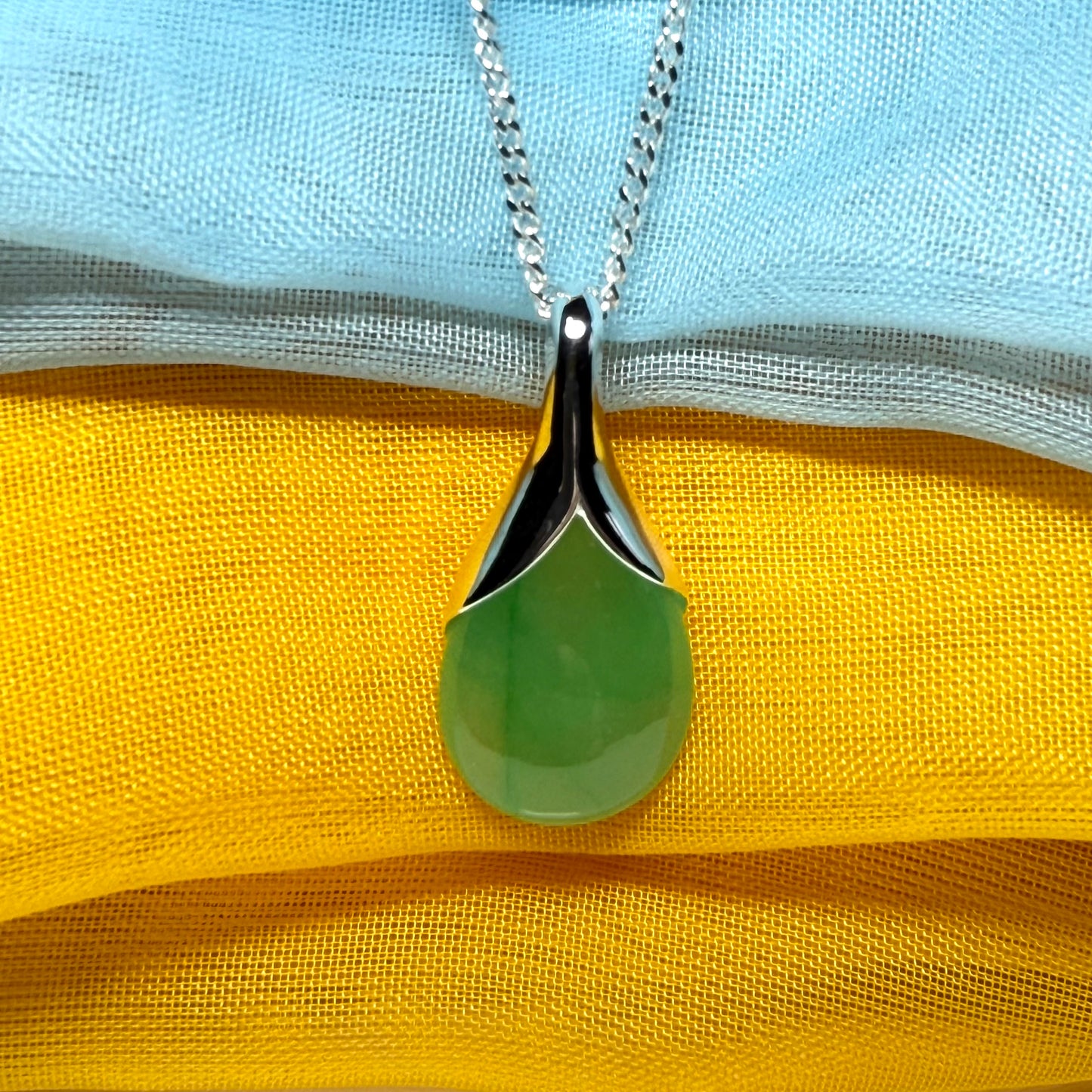 A real jade teardrop shaped designed green necklace or pear shape pendant