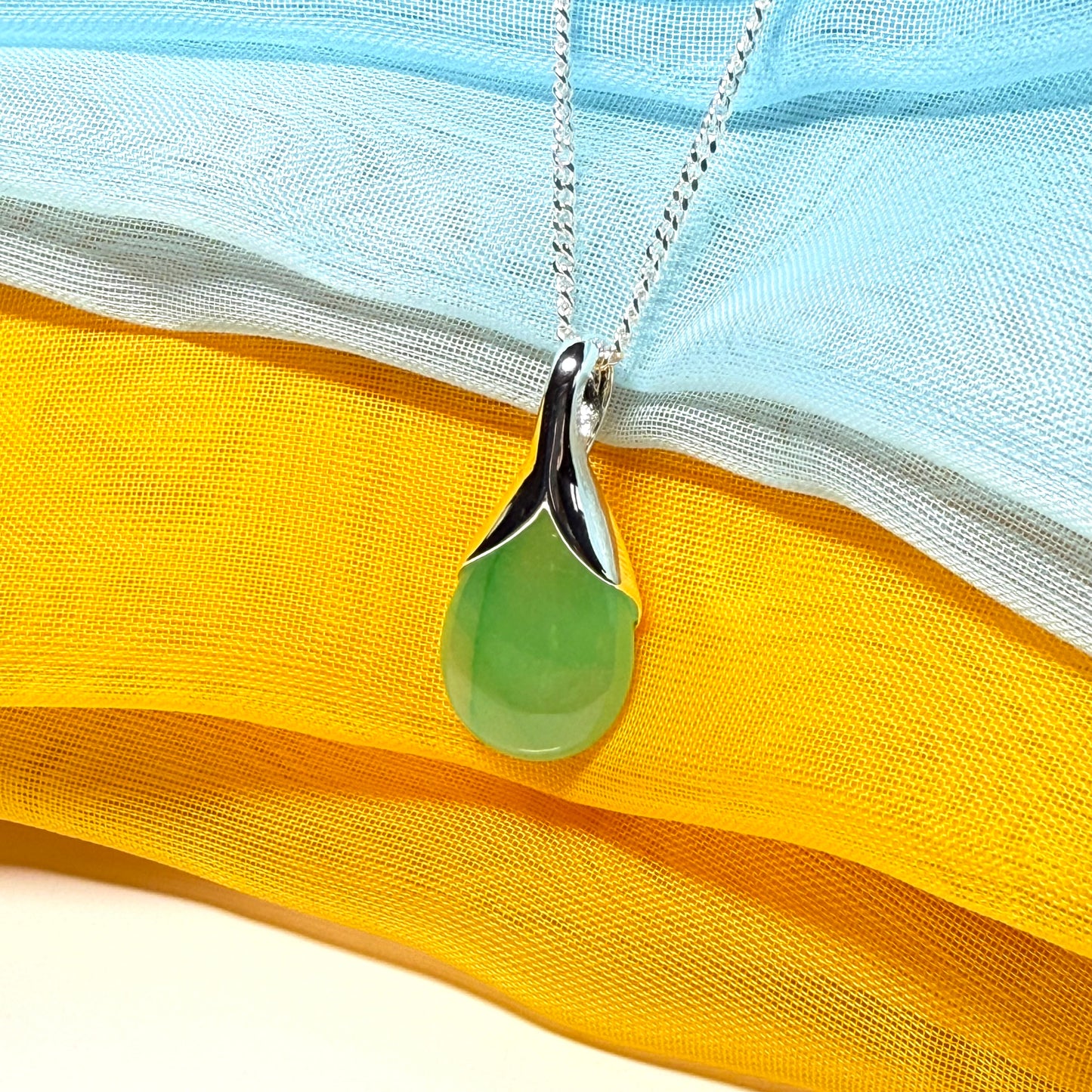 A real jade teardrop shaped designed green necklace or pear shape pendant