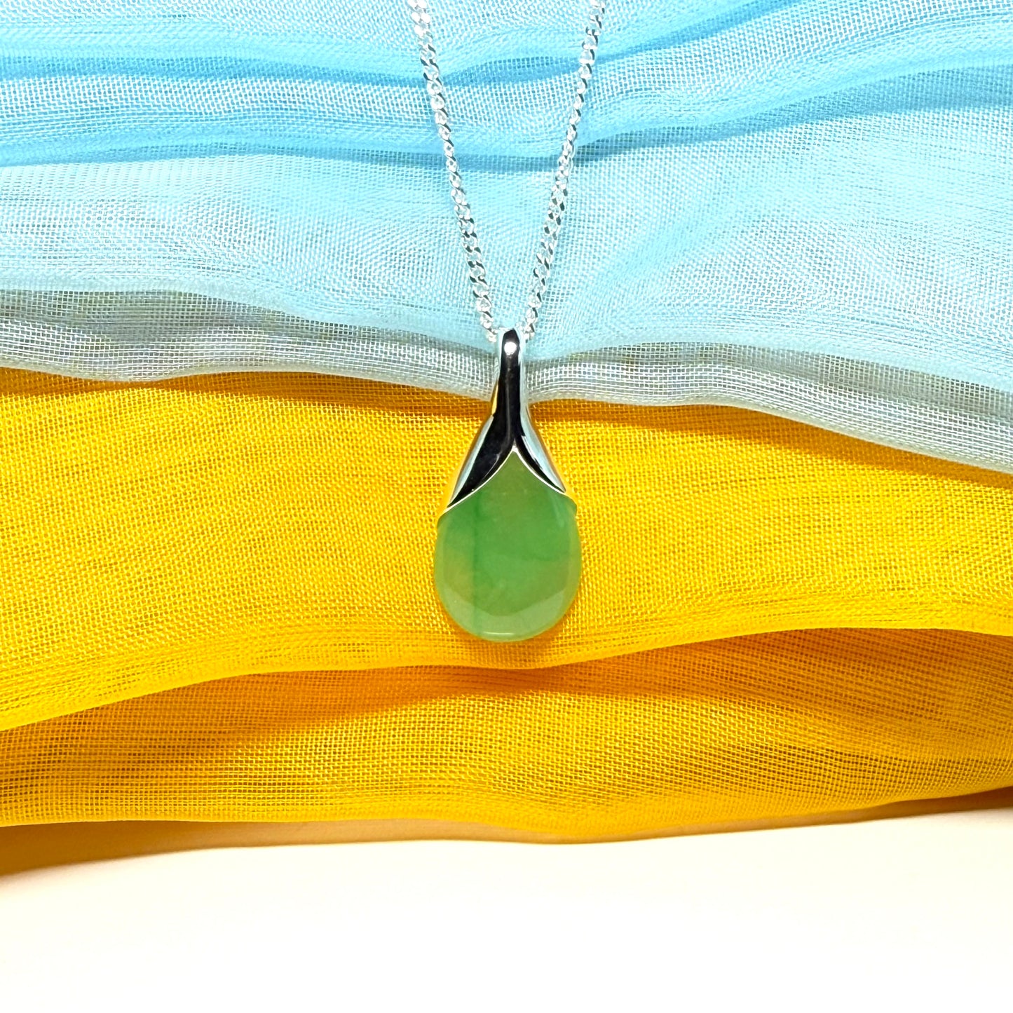 A real jade teardrop shaped designed green necklace or pear shape pendant