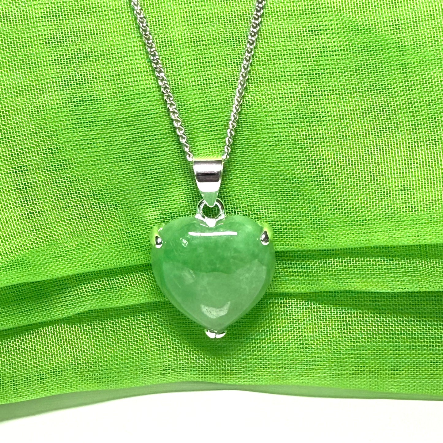 A real light green jade necklace heart shape sterling silver pendant
