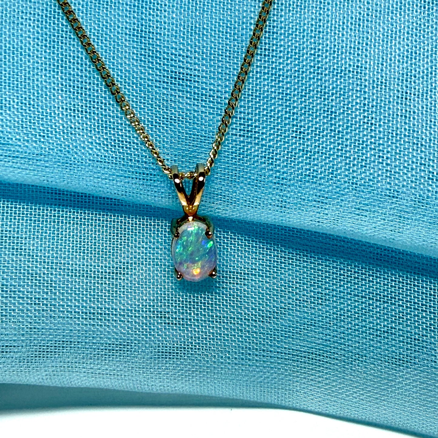 Real opal pendant oval yellow gold