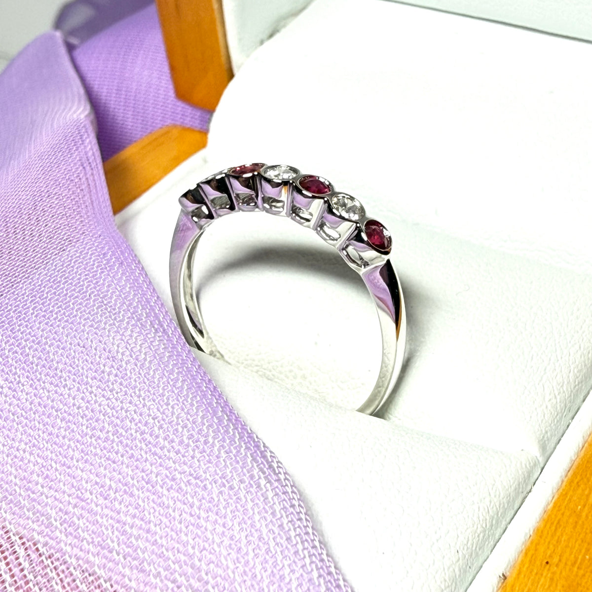 A real ruby and diamond white gold eternity ring smooth setting