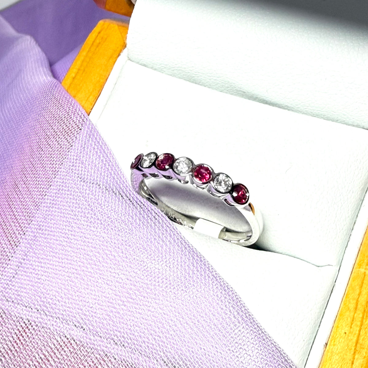 A real ruby and diamond white gold eternity ring smooth setting