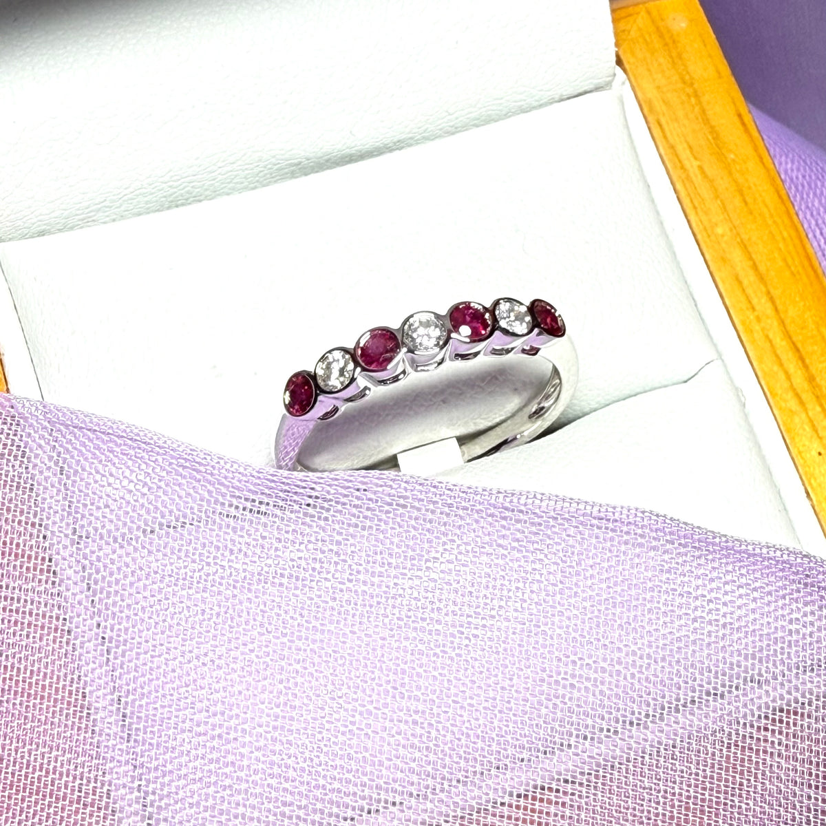 A real ruby and diamond white gold eternity ring smooth setting