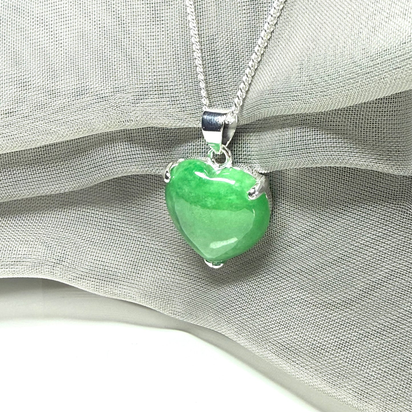 A really beautiful real green jade necklace heart shaped sterling silver, a stunning pendant