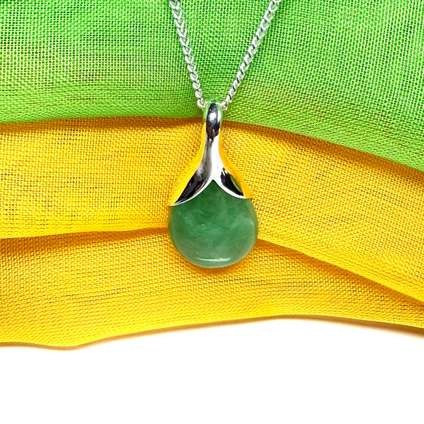 A really gorgeous real green jade pendant in a teardrop or pear shape, a really meaningful designed necklace