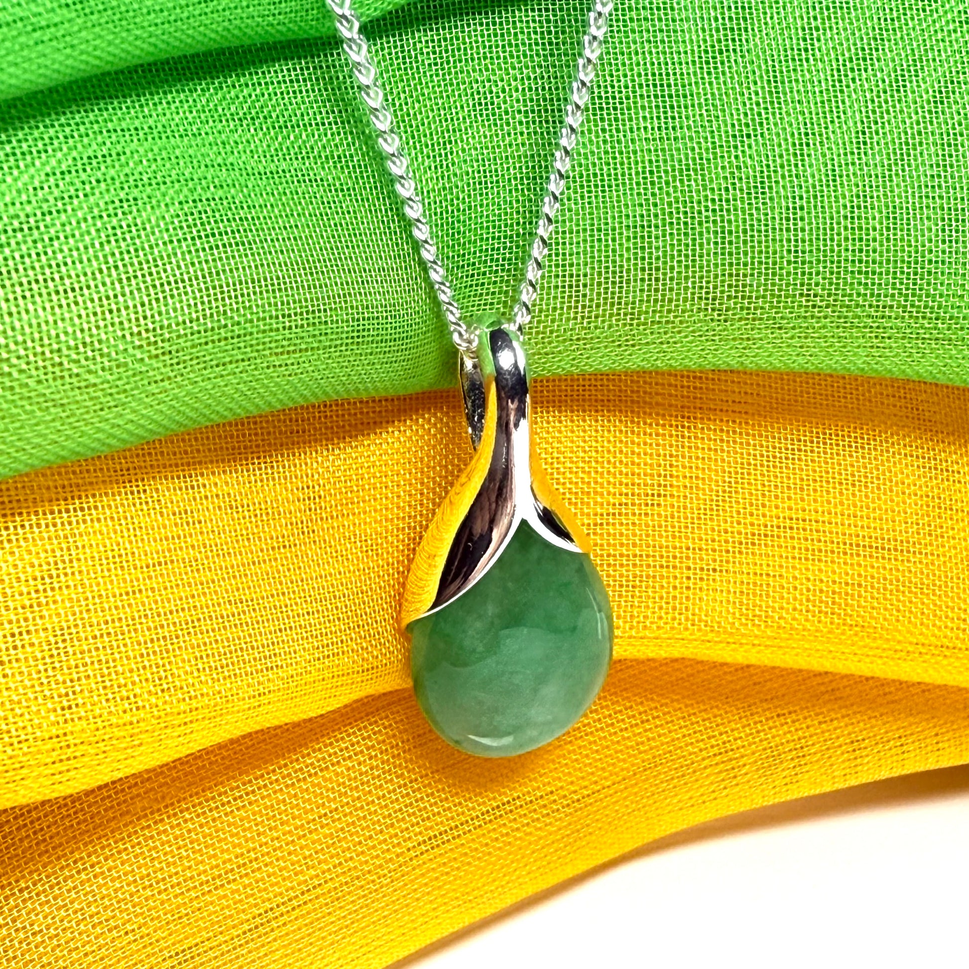 A really gorgeous real green jade pendant in a teardrop or pear shape, a really meaningful designed necklace