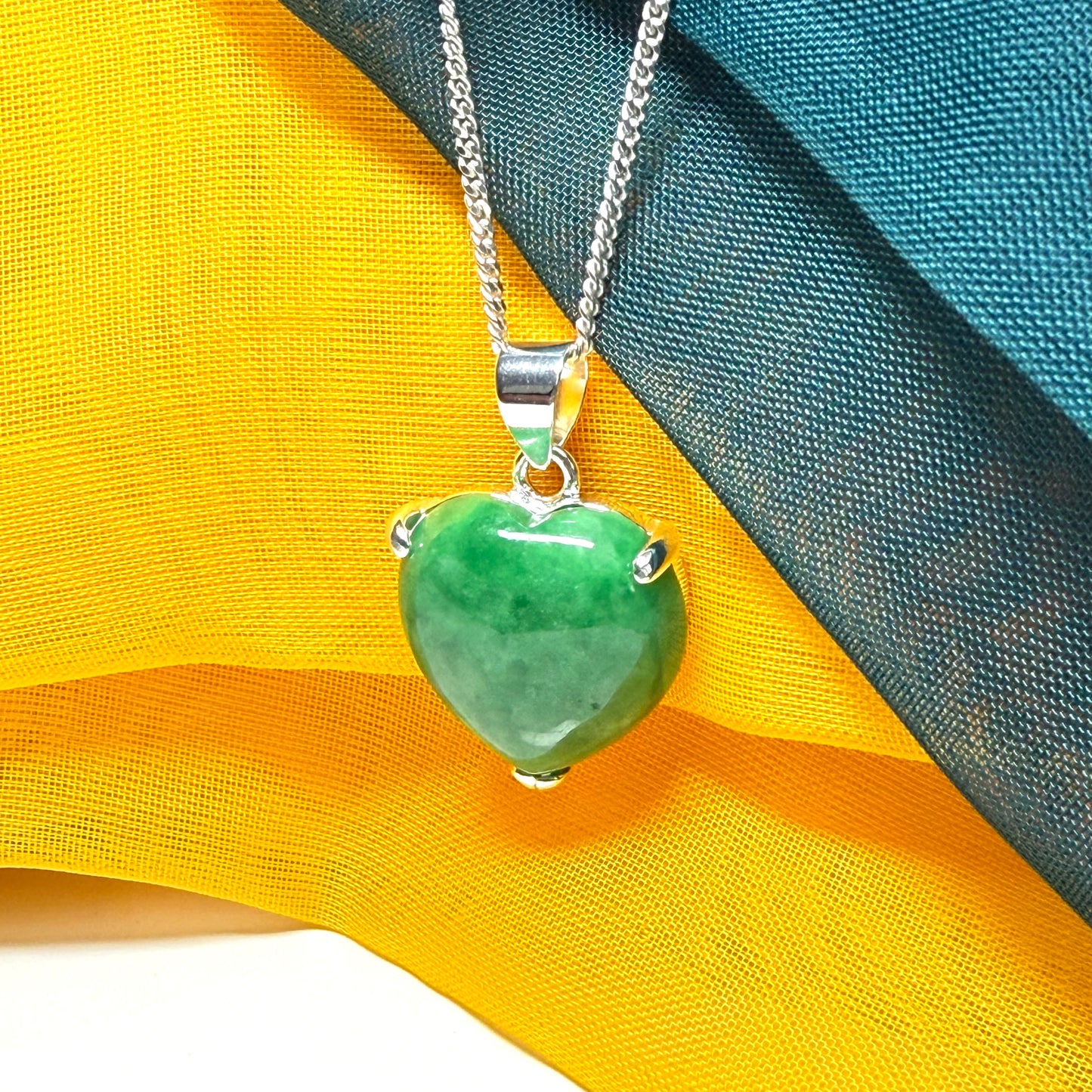 A really stunning real green jade necklace heart shaped sterling silver with a curb chain included as well