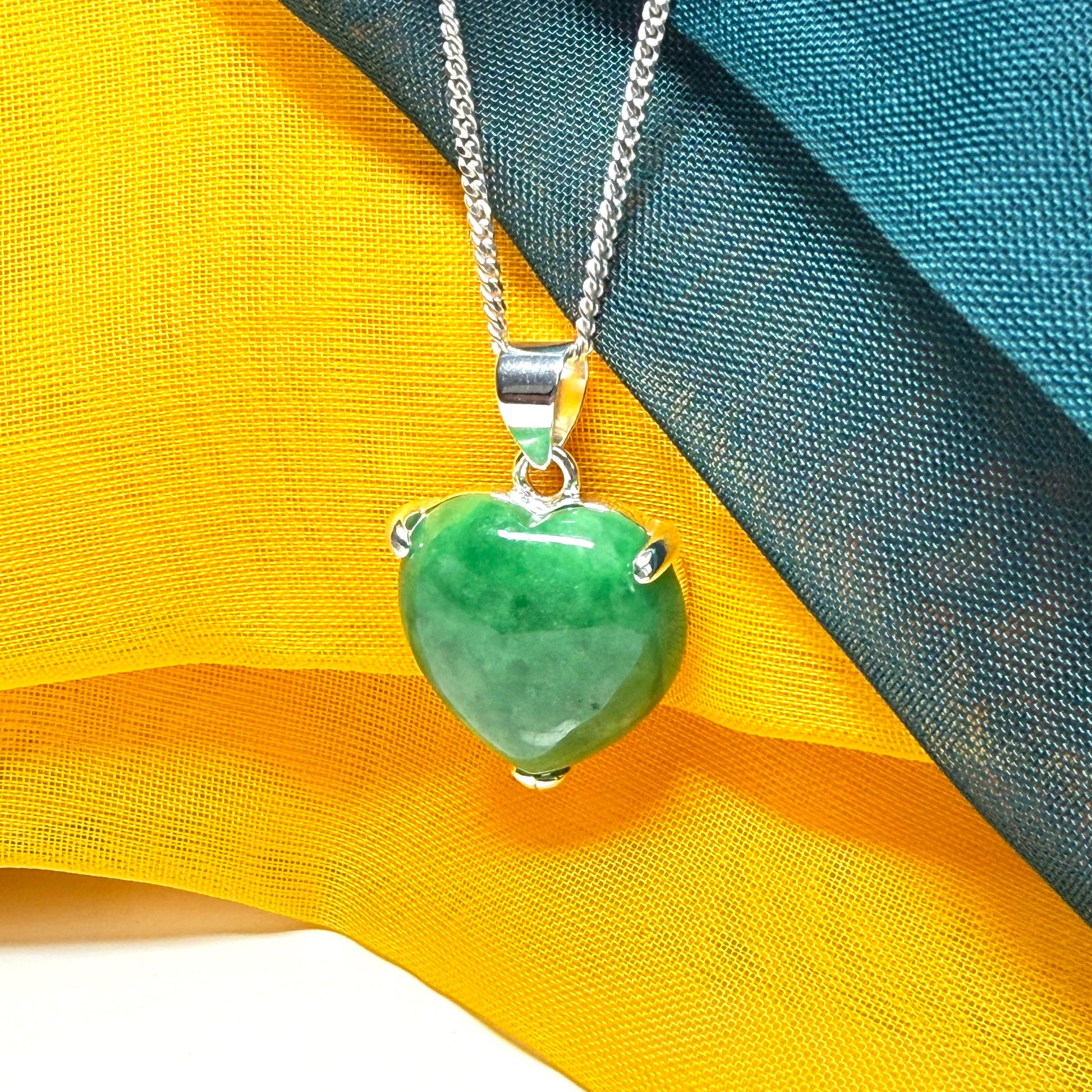 A really stunning real green jade necklace heart shaped sterling silver with a curb chain included as well
