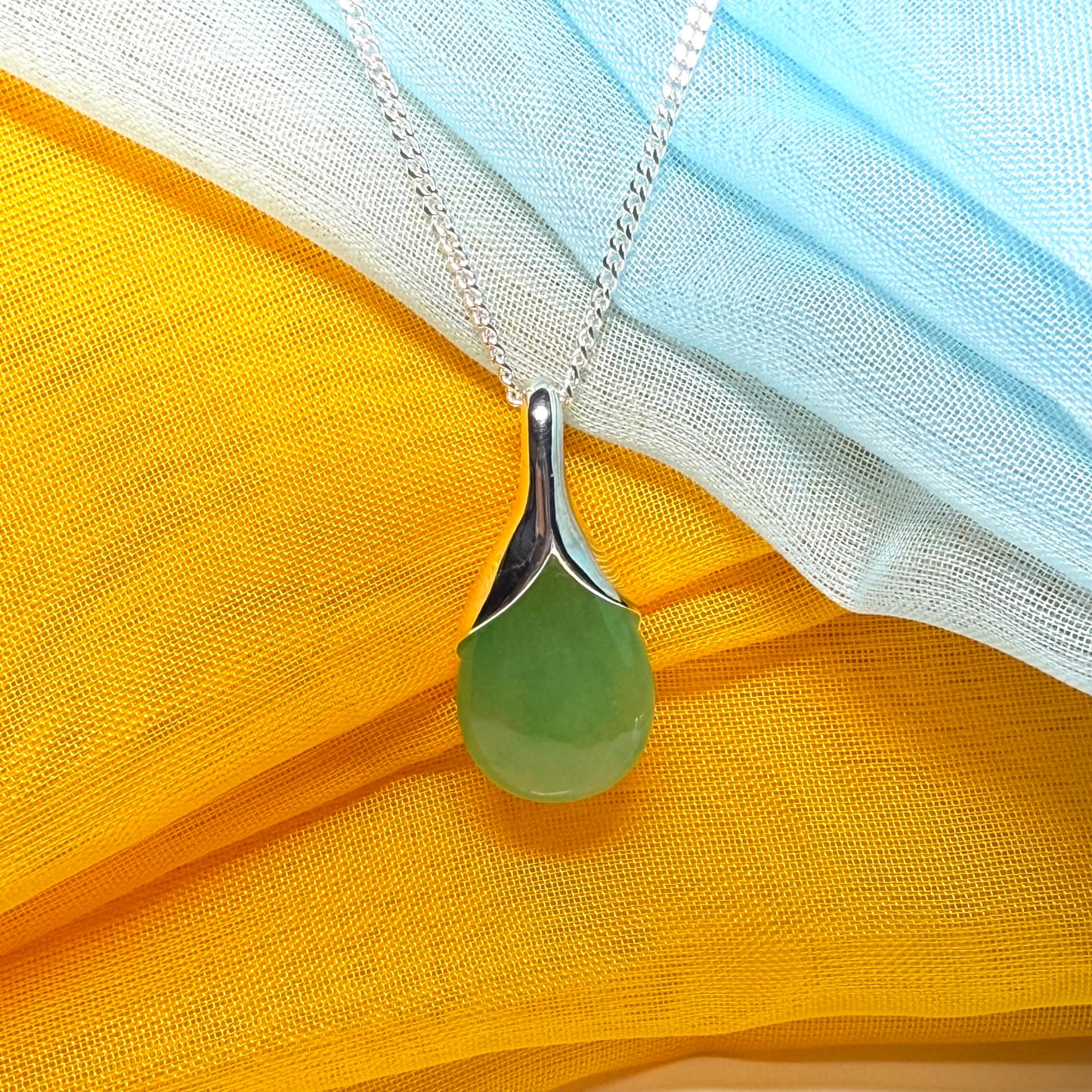 A really stunning real green jade necklace in a teardrop, a timeless designed pendant