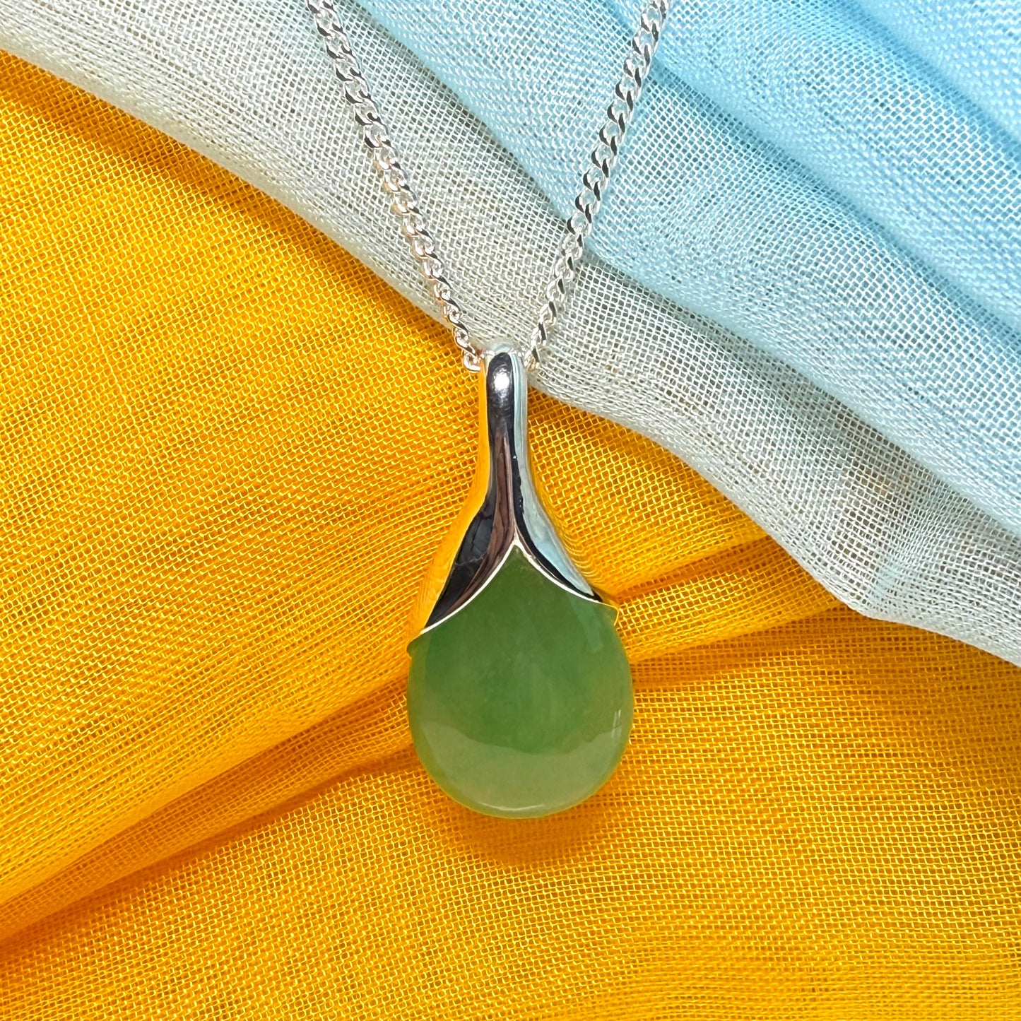 A really stunning real green jade necklace in a teardrop, a timeless designed pendant