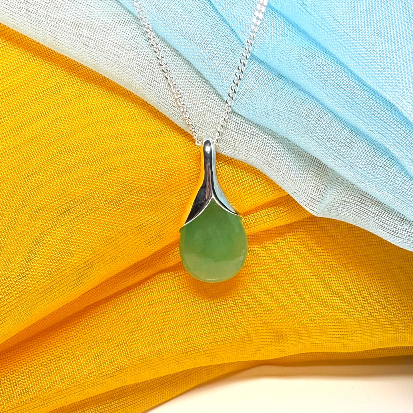 A really stunning real green jade necklace in a teardrop, a timeless designed pendant