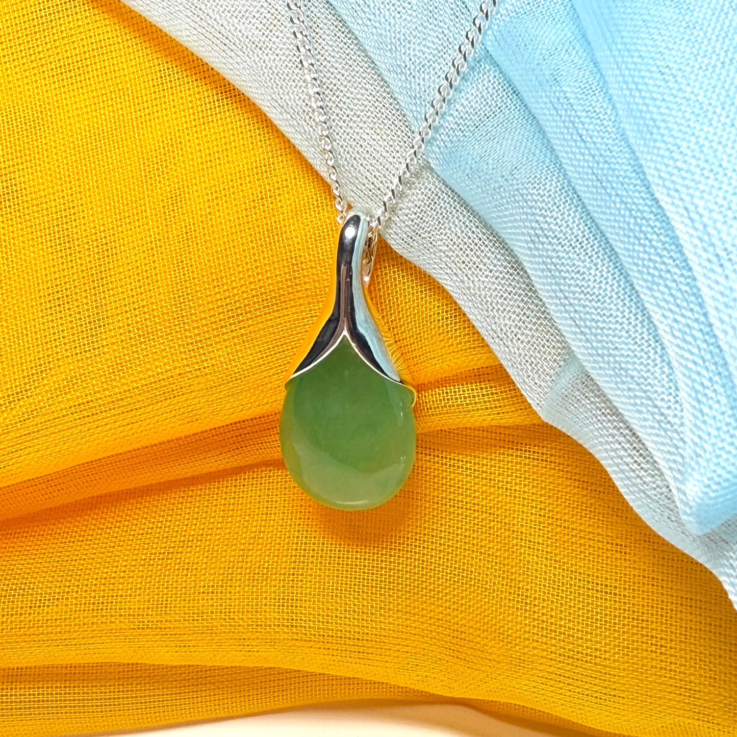A really stunning real green jade necklace in a teardrop, a timeless designed pendant