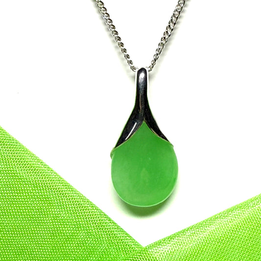 A really stunning real green jade necklace in a teardrop or a pear shape including a solid curb chain