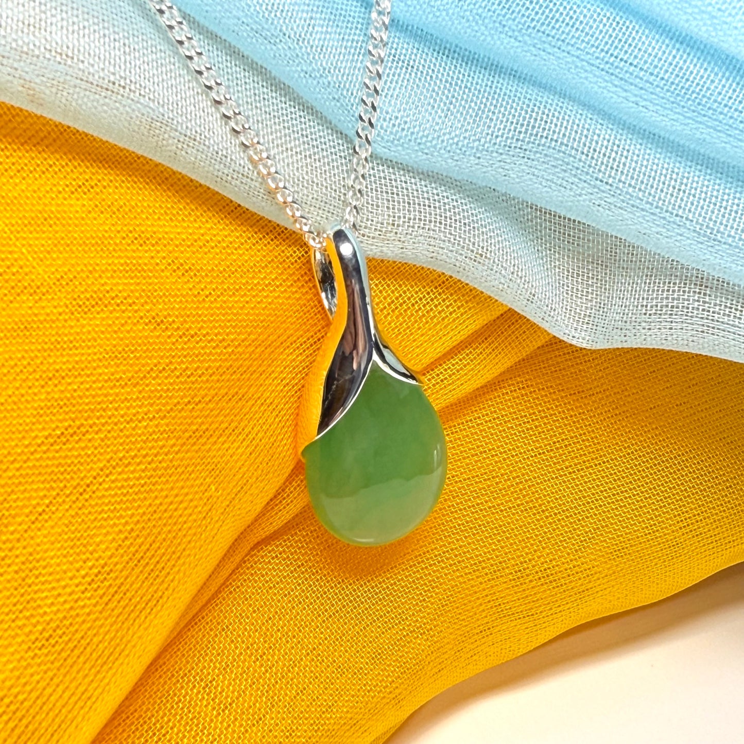 A really stunning real green jade necklace in a teardrop, a timeless designed pendant