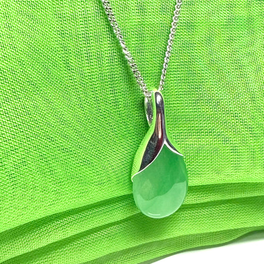 A really stunning real green jade necklace with a pear shaped design including a solid chain