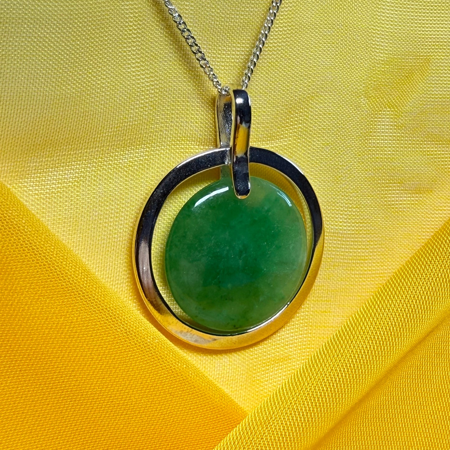 A shimmering large round halo necklace sterling silver circle shaped green real jade
