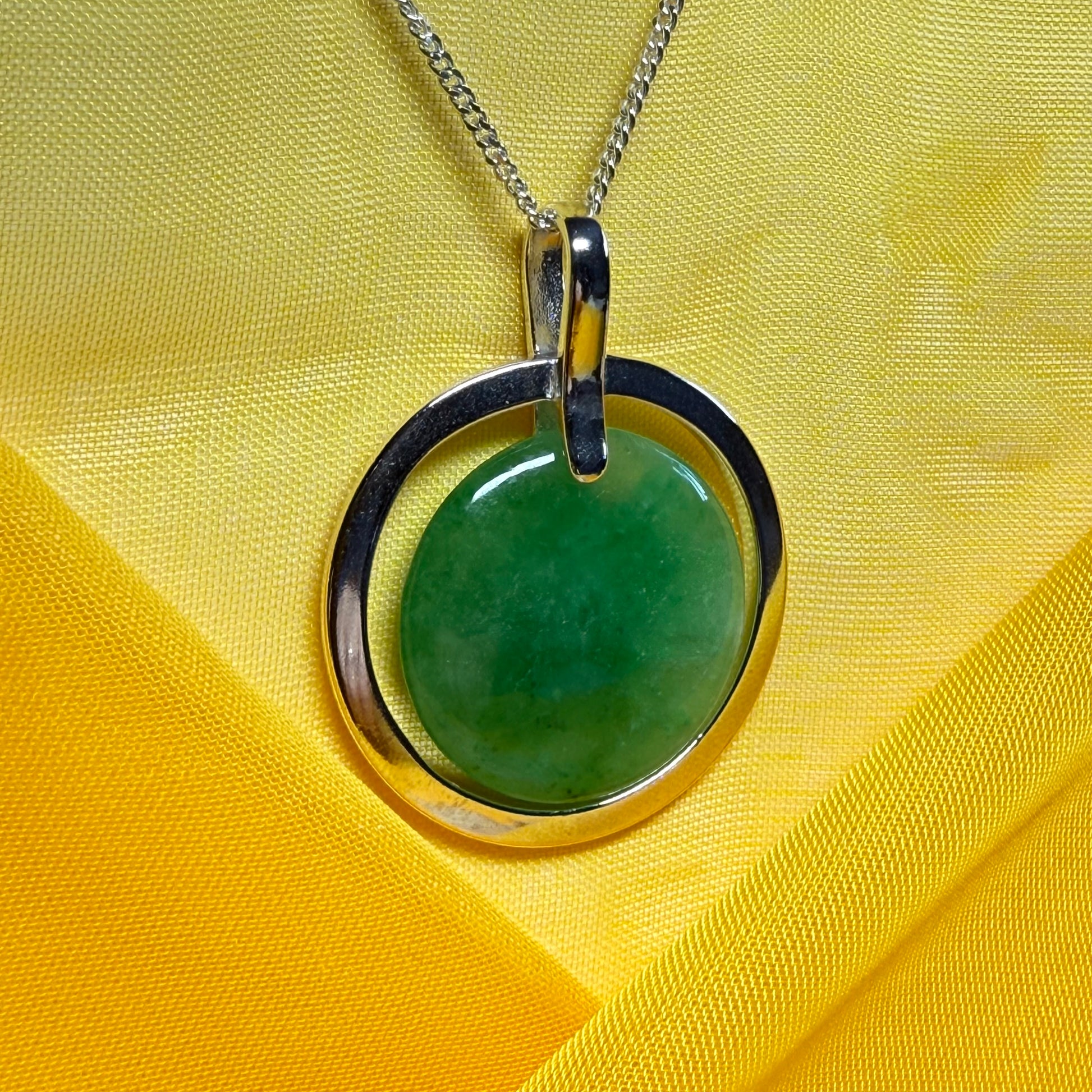A shimmering large round halo necklace sterling silver circle shaped green real jade