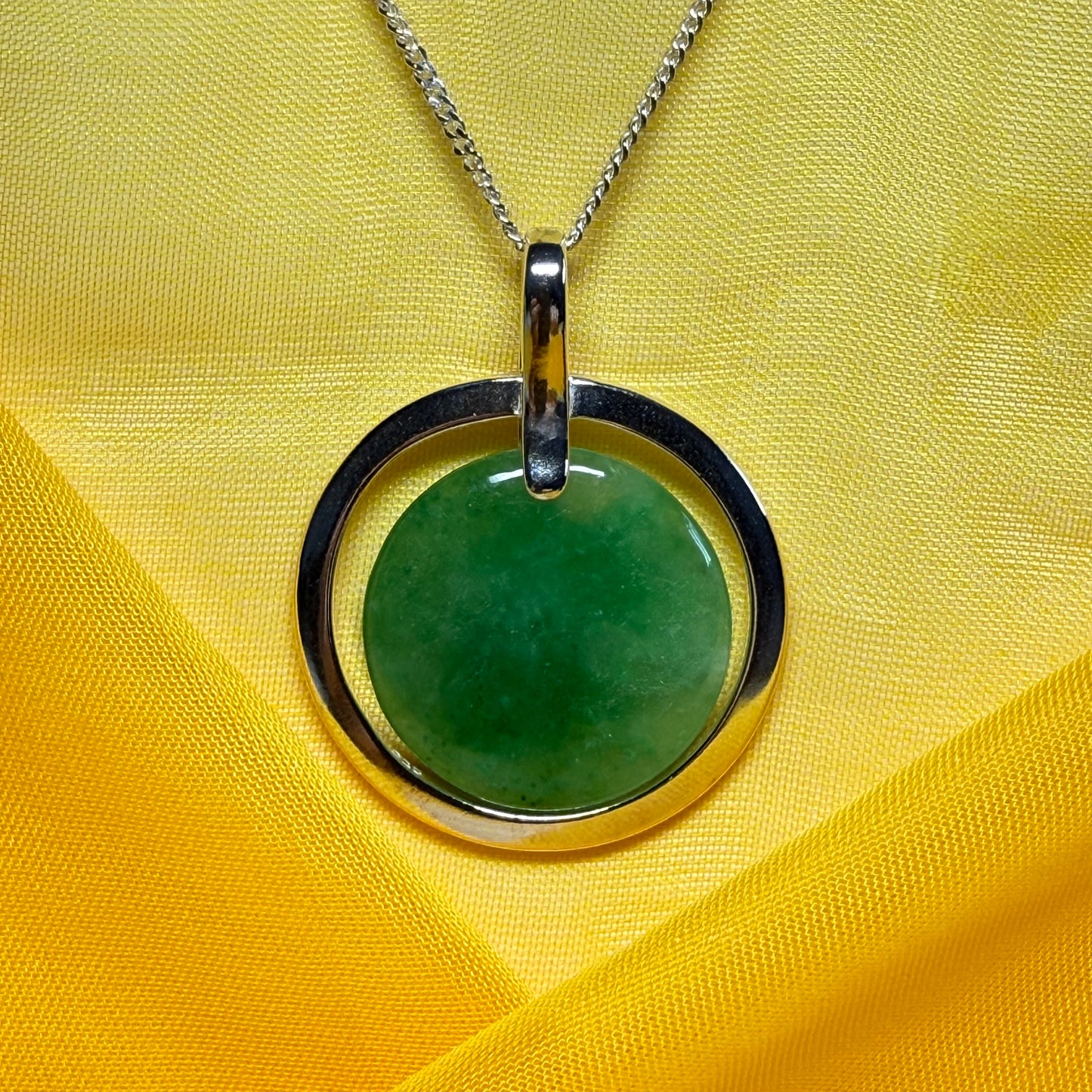 A shimmering large round halo necklace sterling silver circle shaped green real jade