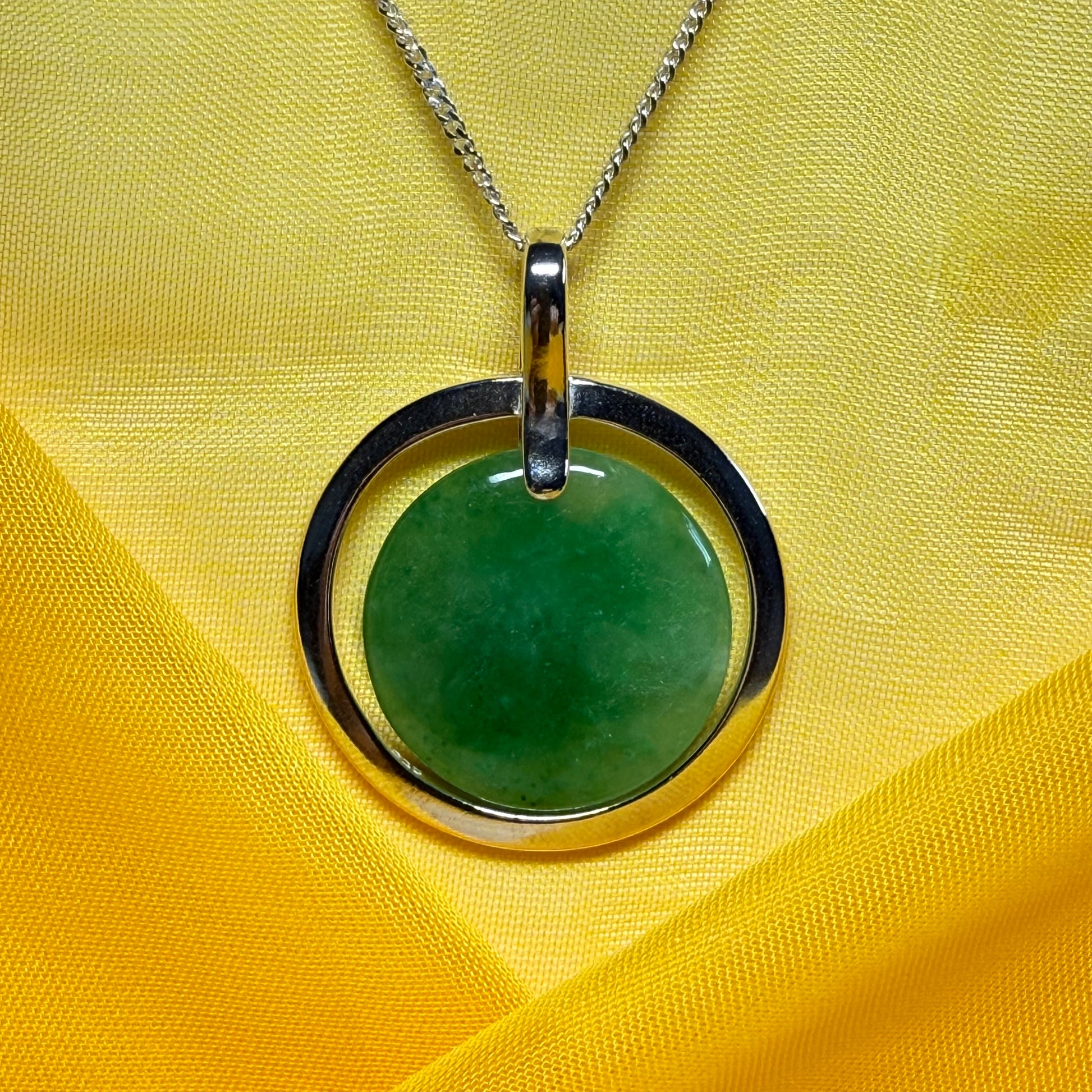 A shimmering large round halo necklace sterling silver circle shaped green real jade