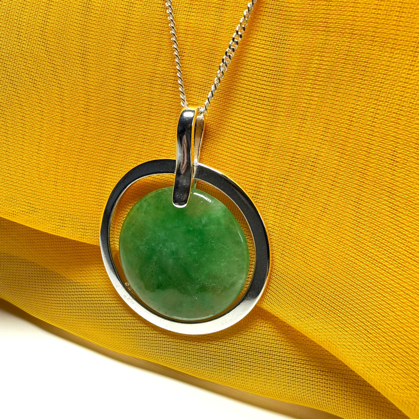 A shimmering large round halo necklace sterling silver circle shaped green real jade