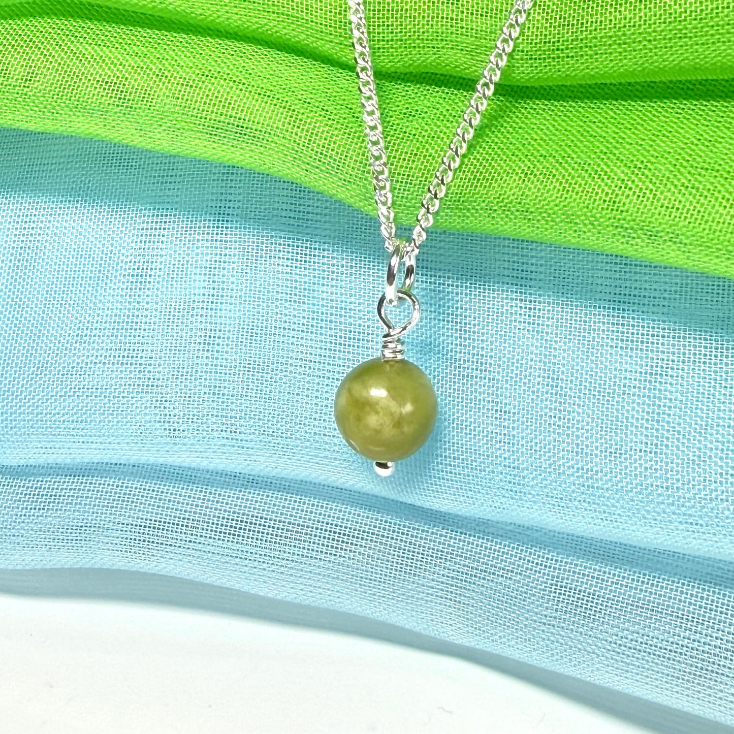 A small real green gypsum necklace ball shaped, a really gorgeous round pendant