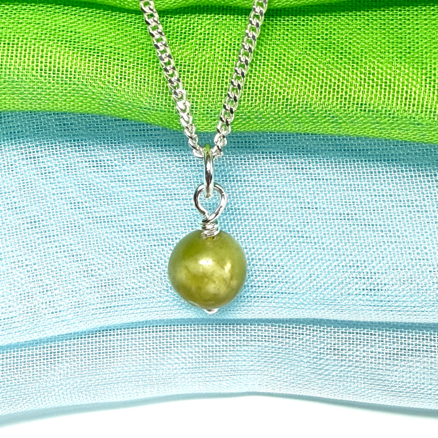A small real green gypsum necklace ball shaped, a really gorgeous round pendant