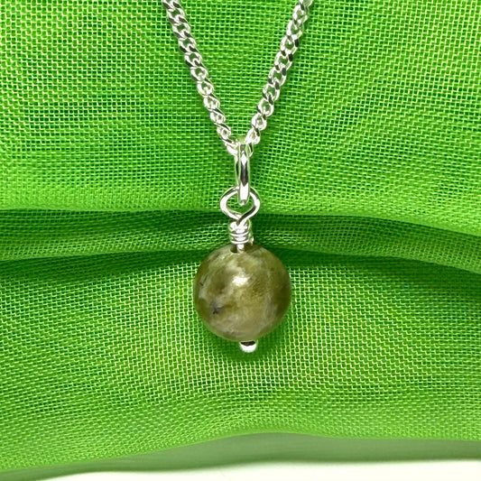 A small real green gypsum round necklace ball shaped, a traditional pendant