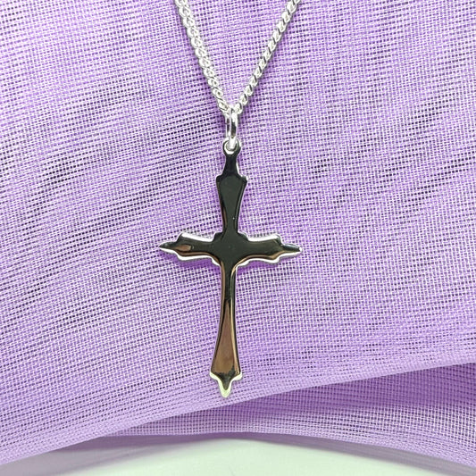 A solid fancy shaped sterling silver cross necklace pendant with a chain included