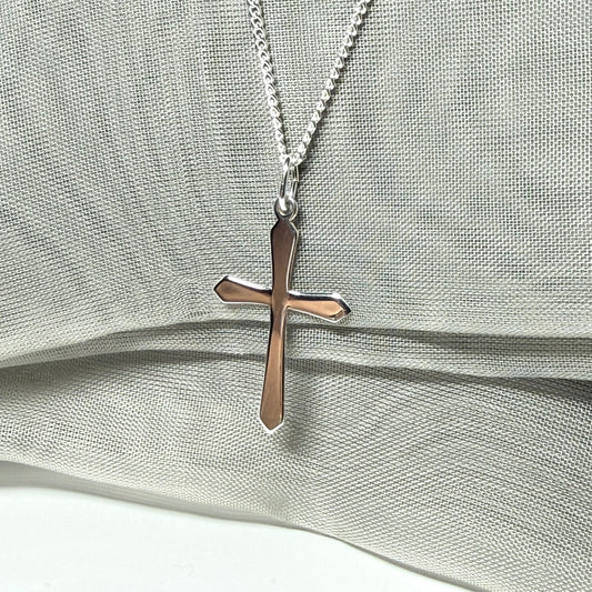 A solid sterling silver cross necklace fancy shaped pendant with a chain