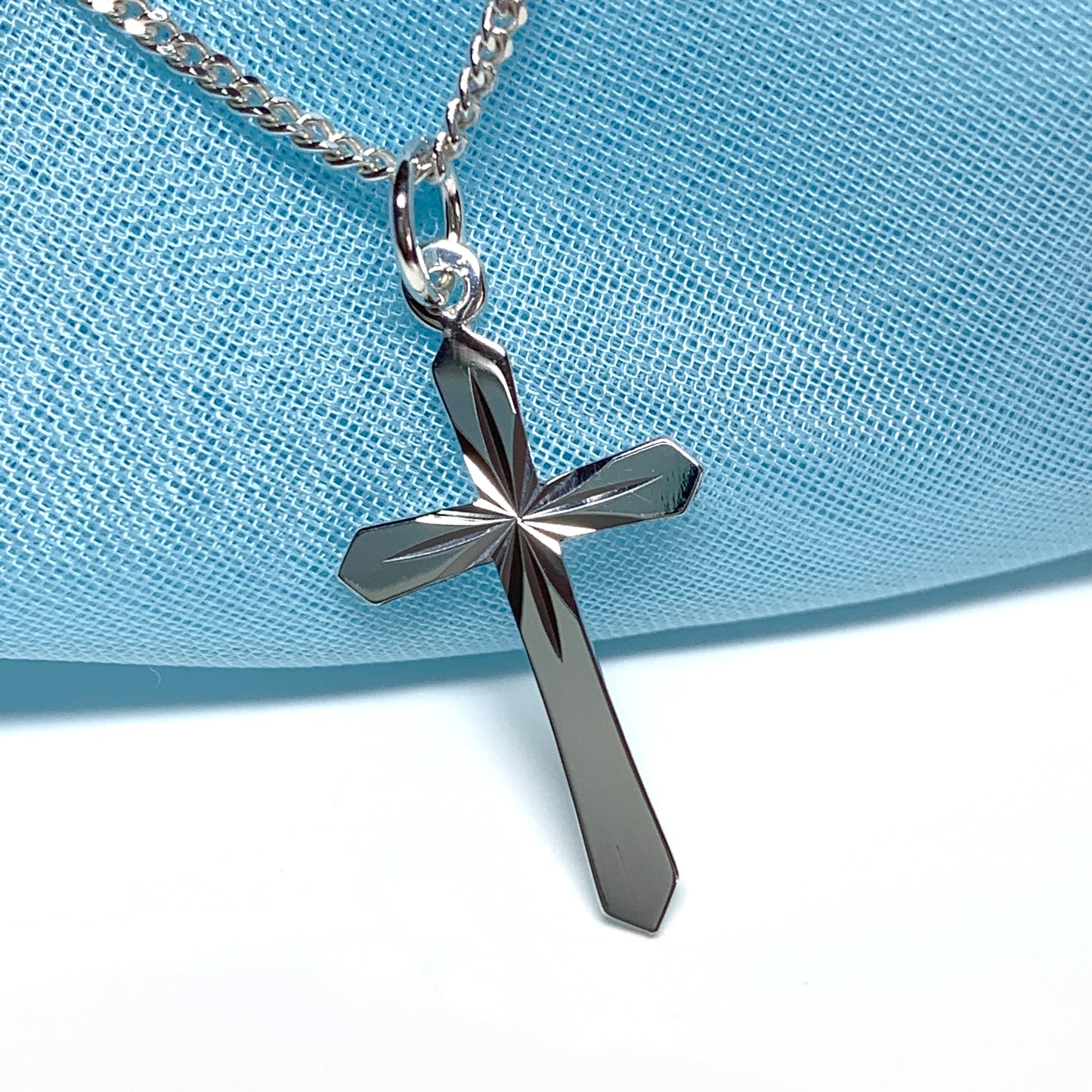 A Sterling silver diamond cut cross necklace including chain