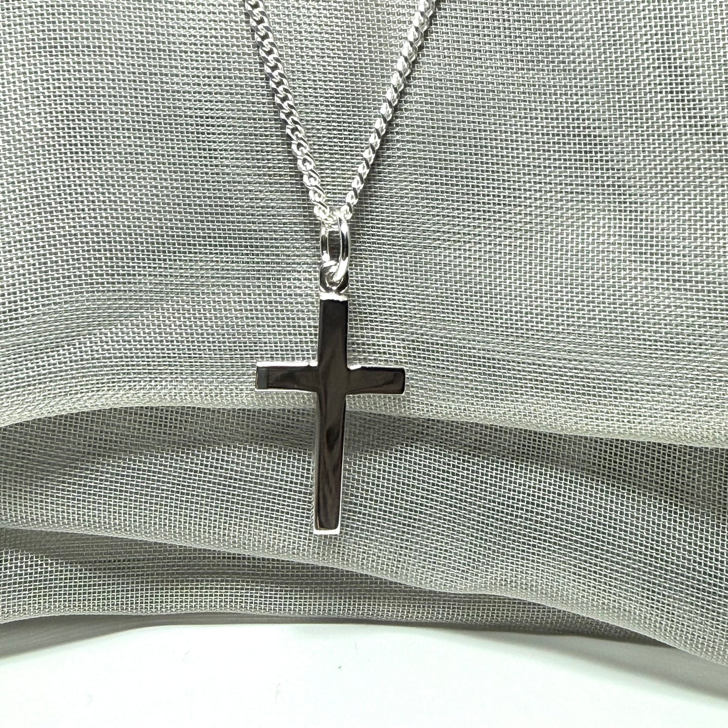 Sterling silver plain polished cross flat design with a chain