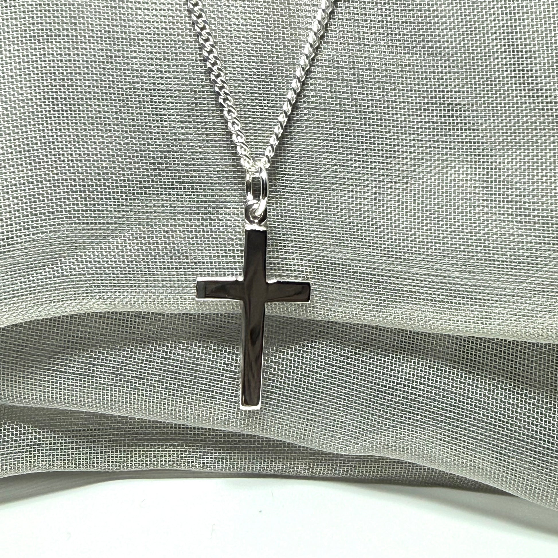 Sterling silver plain polished cross flat design with a chain