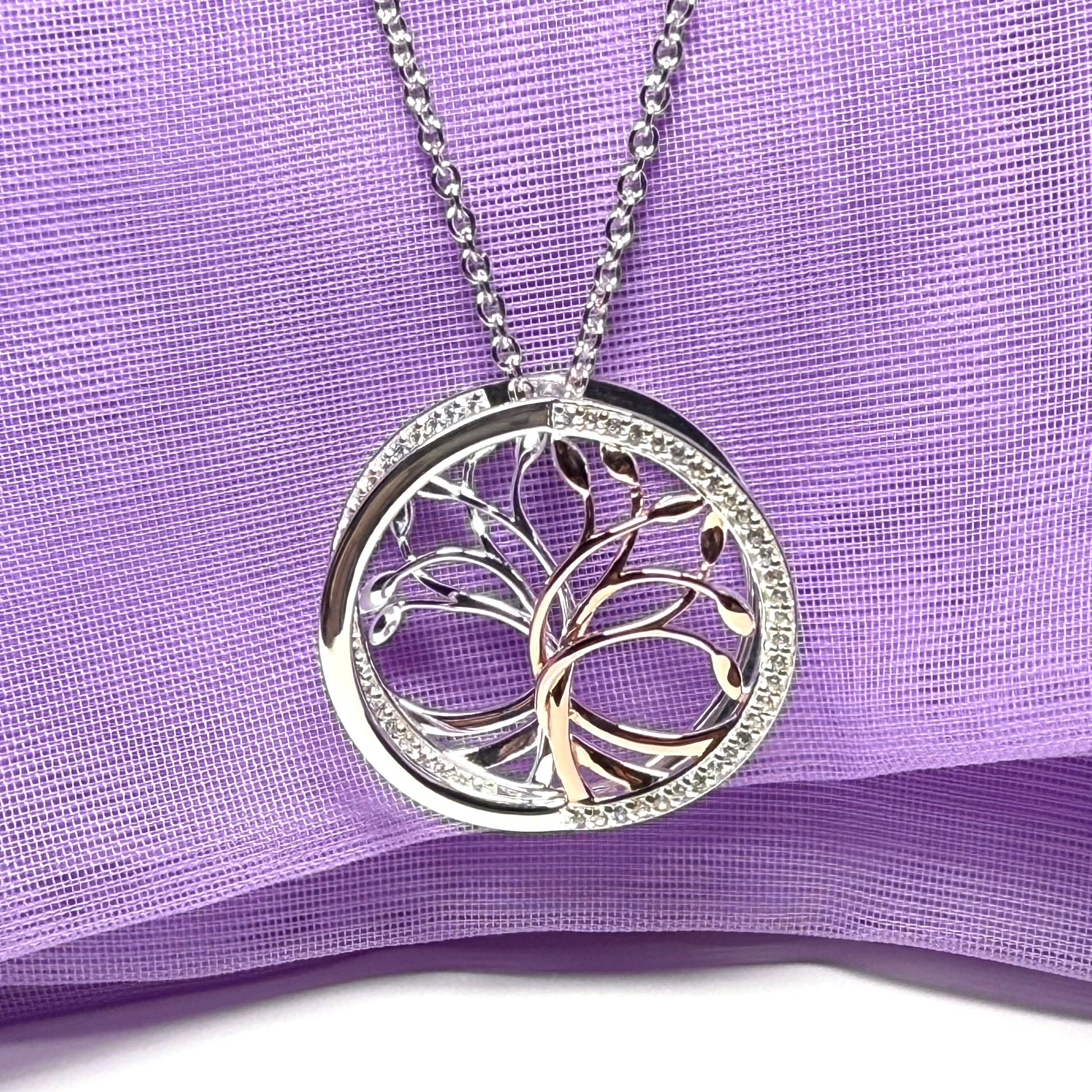 A sterling silver solid round open pierced fancy swirl Tree of Life necklace