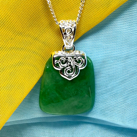 A stunning, a real green jade necklace large shaped with a patterned top pendant